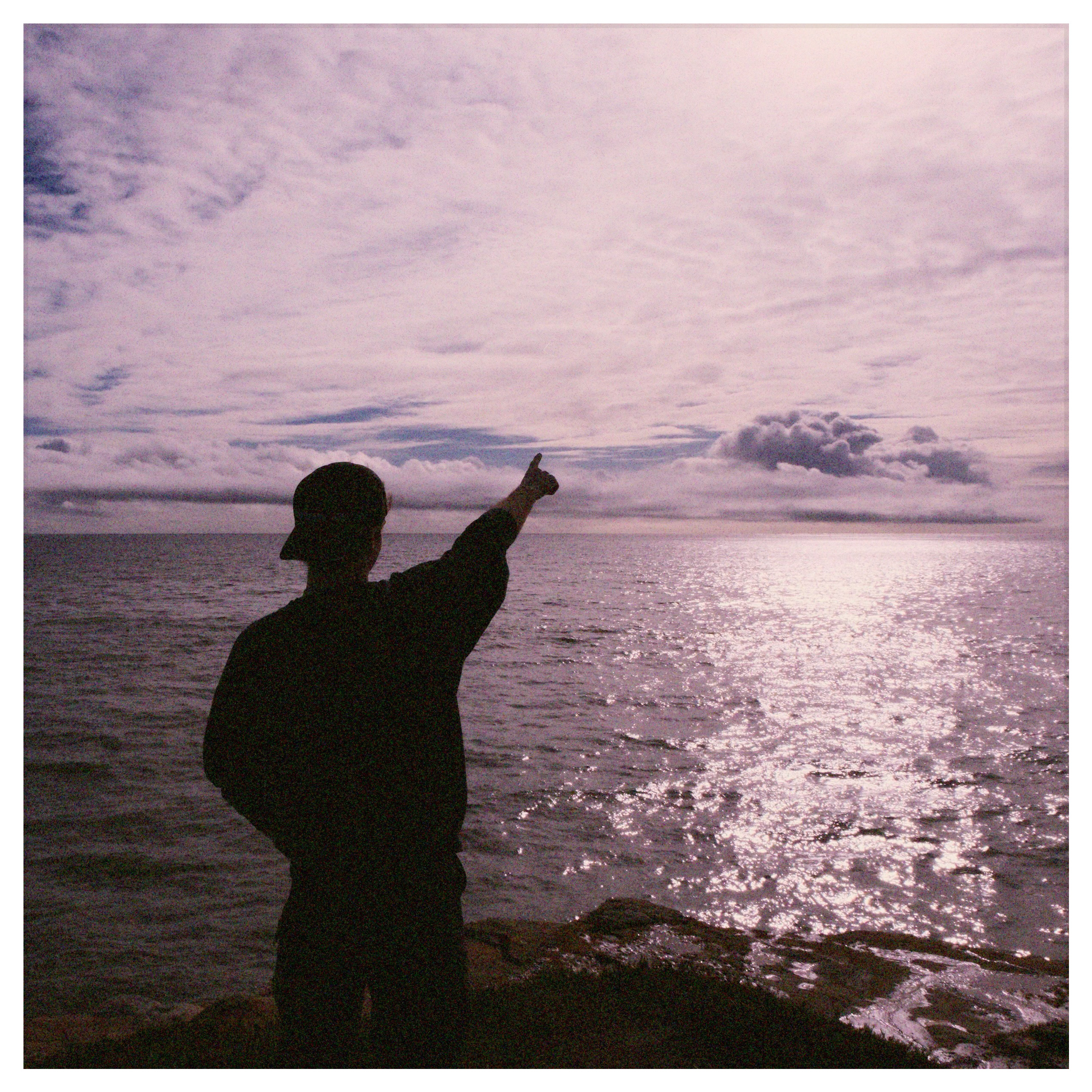 me pointing out across a vast ocean landscape